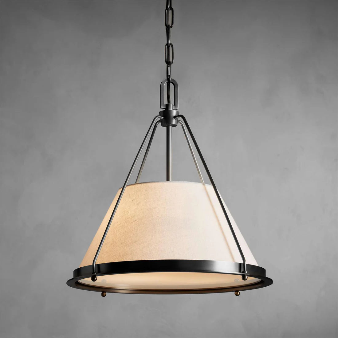 Melton Pendant Light – a striking blend of smooth brass and textured linen fabric, featuring industrial-inspired brass arms and flared shades, elegantly accented with brass detailing at the base.