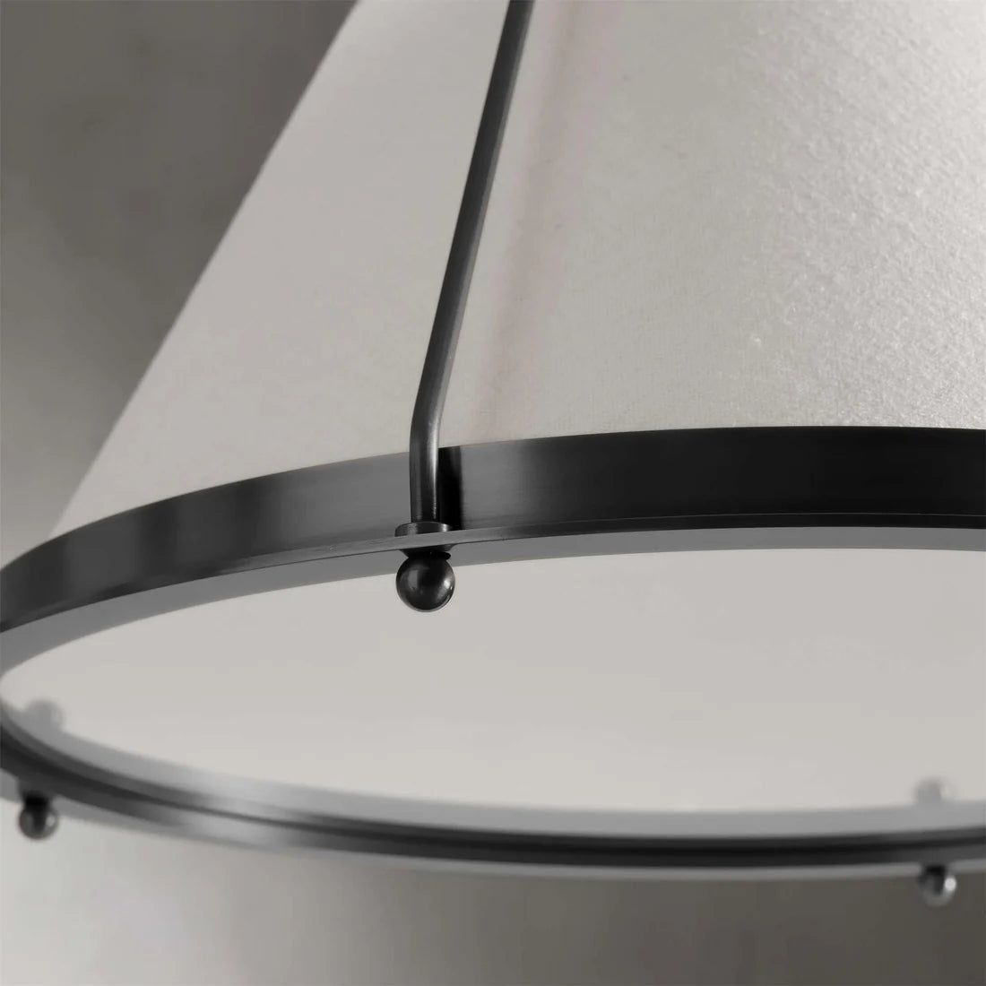 Melton Pendant Light – a striking blend of smooth brass and textured linen fabric, featuring industrial-inspired brass arms and flared shades, elegantly accented with brass detailing at the base.