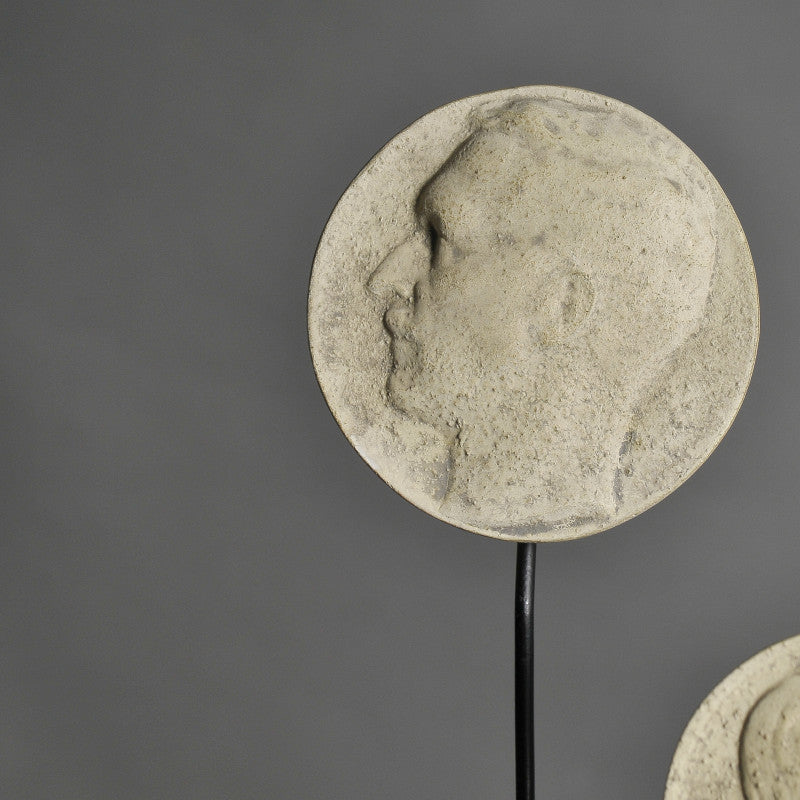 19th-Century Stucco Collector's Medallions – artist-crafted commemorative pieces, displayed on matte black metal stands, honoring past exhibitions and events.