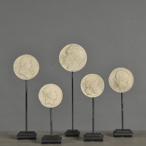 19th-Century Stucco Collector's Medallions – artist-crafted commemorative pieces, displayed on matte black metal stands, honoring past exhibitions and events.