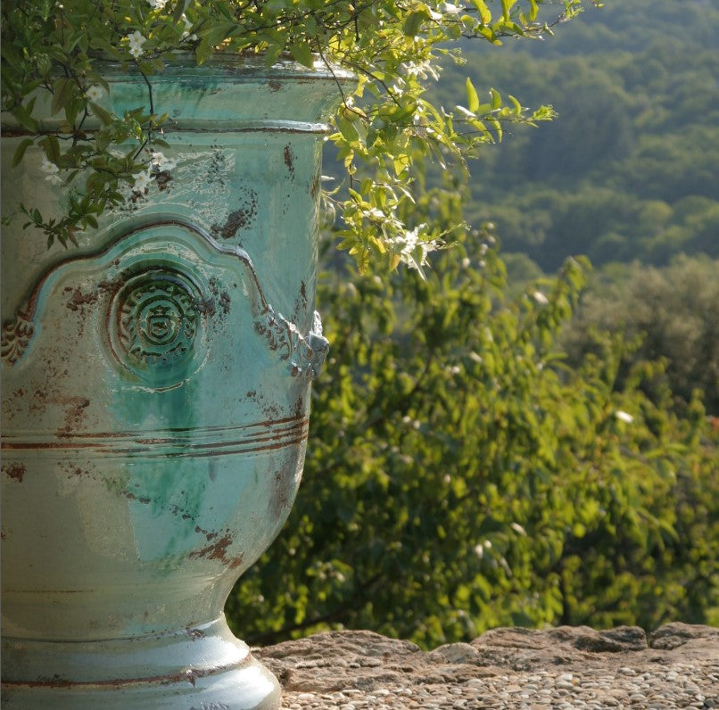 Decorative urn with a natural green background