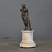 Venus with Apple – elegant sculpture inspired by Greek mythology, standing on a hand-made sandstone column with an antique bronze patina.