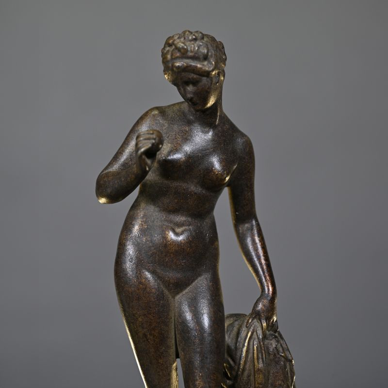 Venus with Apple – elegant sculpture inspired by Greek mythology, standing on a hand-made sandstone column with an antique bronze patina.